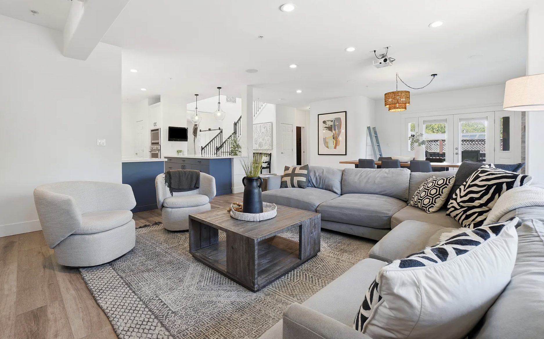 Living room with a sectional sofa opening to the kitchen in a move-in ready San Rafael home