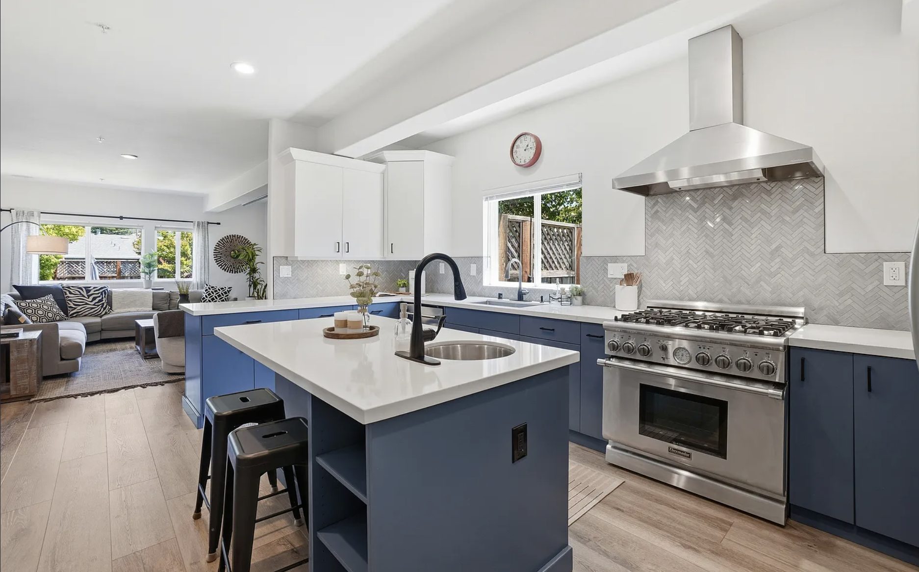 Remodeled kitchen with navy cabinets, a quartz island, and a professional gas range in a turn-key San Rafael home